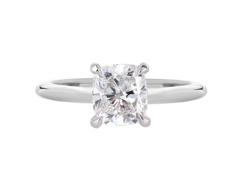 A.G cushion cut solitaire with a round profile band.