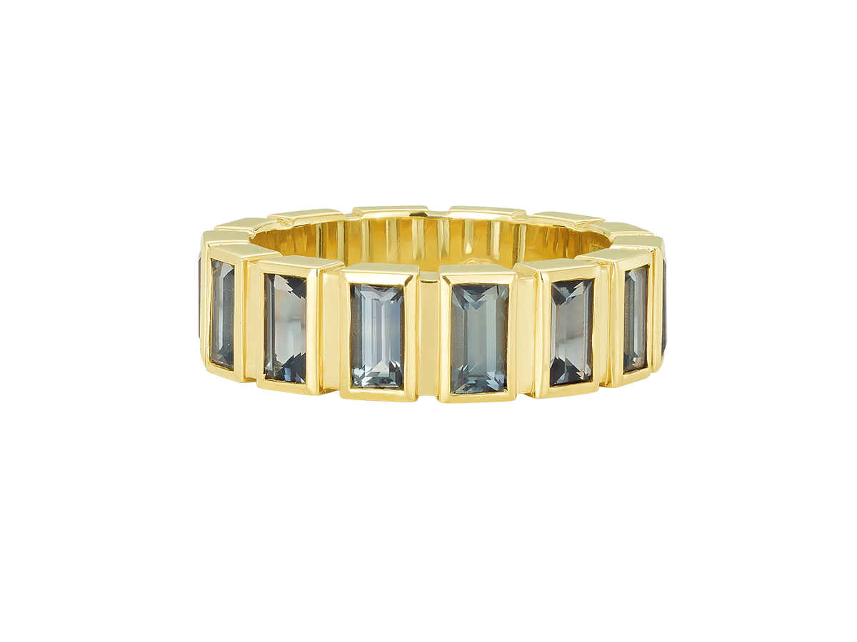 A.G baguette cut bezel set eternity band with green sapphires and yellow gold.