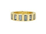 A.G baguette cut bezel set eternity band with green sapphires and yellow gold.
