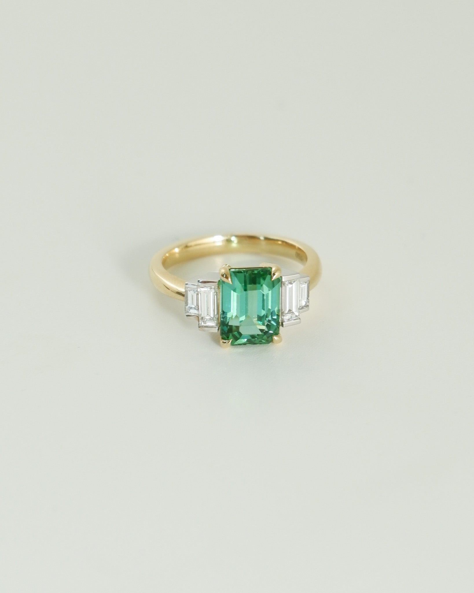 A.G tourmaline and diamond step style ring on white background.