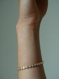 Close up of wrist with yellow gold East-West Oval Diamond Tennis Bracelet on.