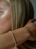 Close up of woman's wrist wearing our East-West Oval Diamond Tennis Bracelet.