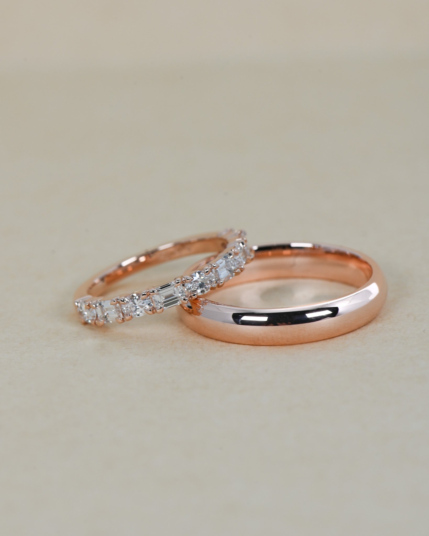 A.G Designer Jeweller signature custom made and designed emerald and oval cut alternating diamond half eternity band stacked with plain wedding band in rose gold.