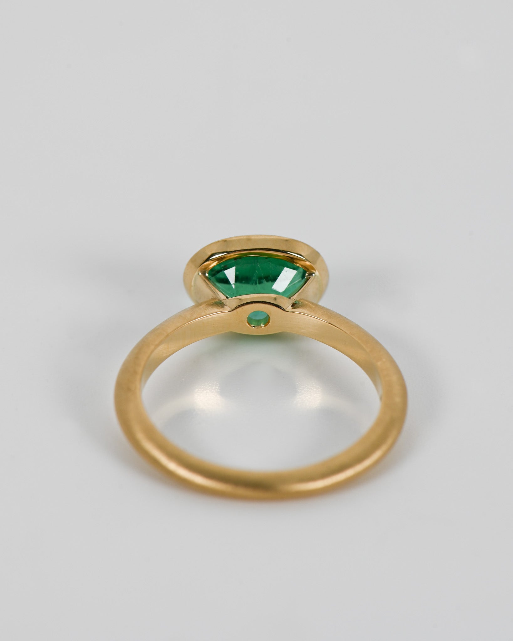 Back view of oval emerald ring.