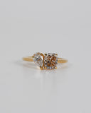 A.G 1.56ct cushion cut champagne diamond and 0.52ct pear cut diamond ring with white background.