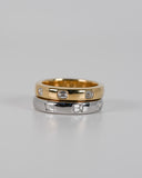 Silver and Gold A.G hammer set emerald cut wedding bands stacked on each other.