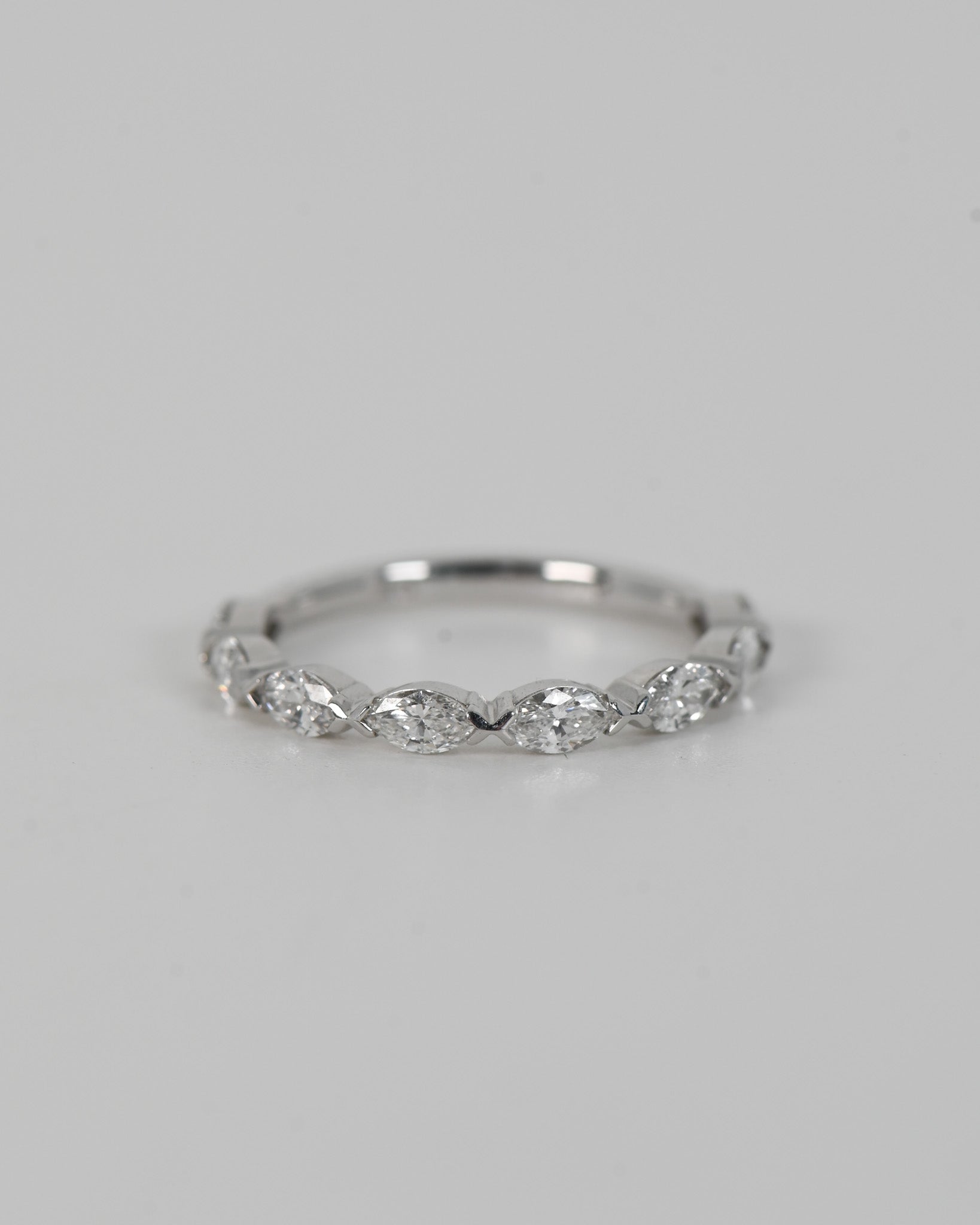 A.G signature marquise diamond V claw women's wedding band on white background.