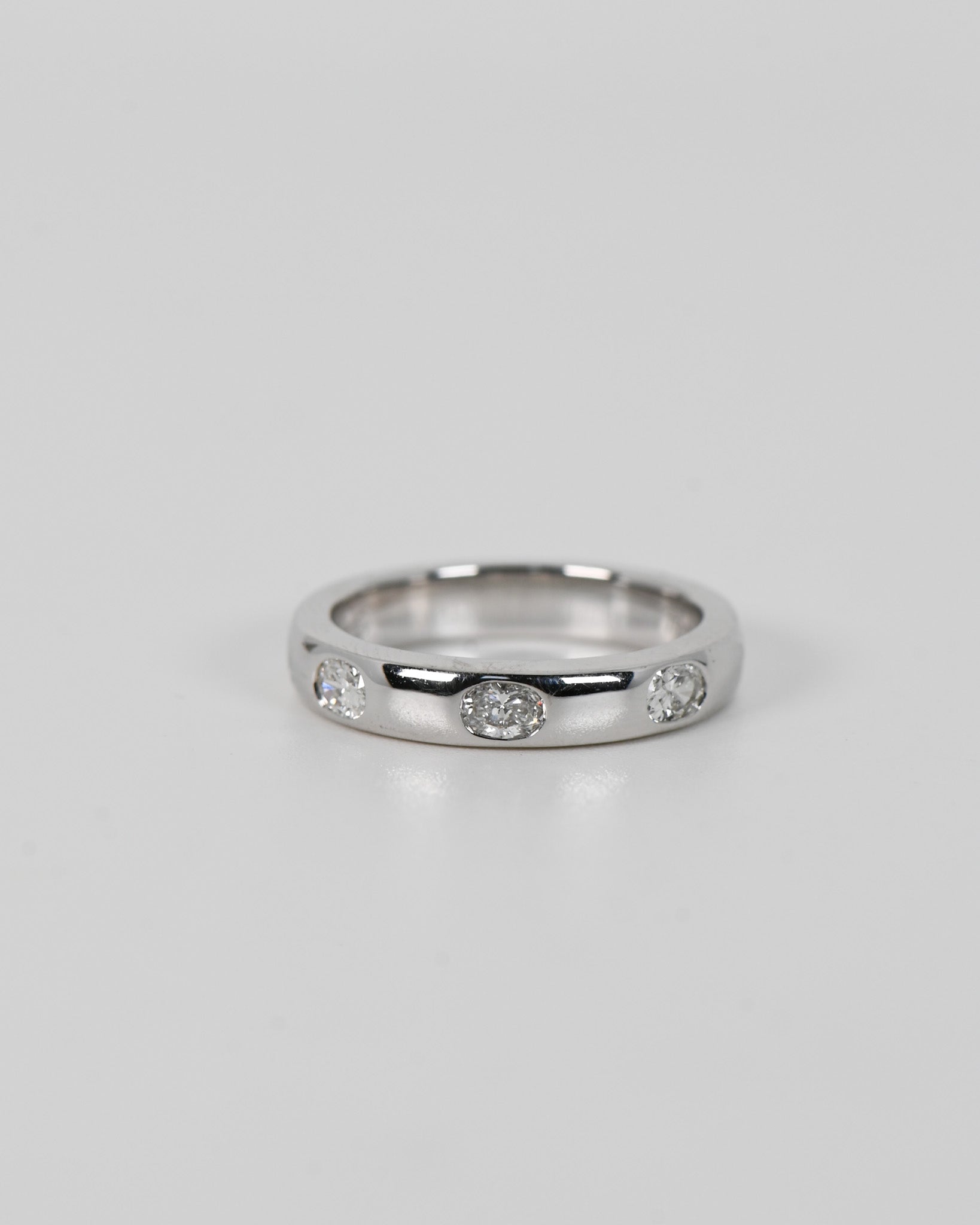 Silver A.G Designer Jeweller signature custom designed hammer set oval cut diamond wedding ring.