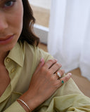 A woman wearing the Graduated Bezel Set Diamond Bracelet on her right wrist
