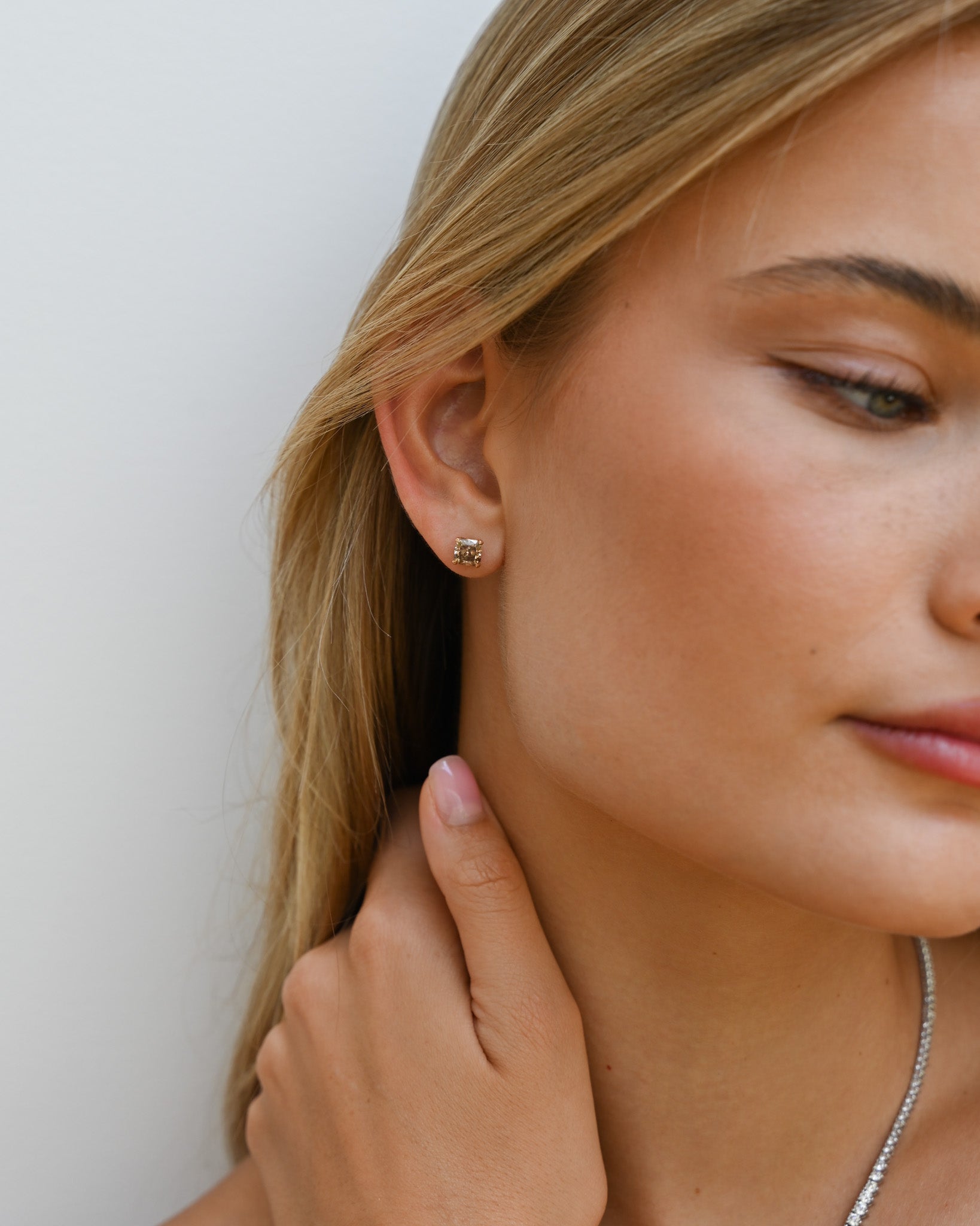 Close up of woman's ear with Champagne Diamond Studs in.