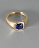 Top view of A.G Designer Jeweller custom designed men's signet ring with royal blue sapphire in yellow gold.
