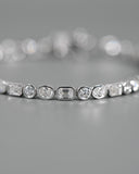 Close up of bezel diamonds in Tri Diamond Bezel Bracekelt.