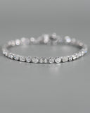 Close up view of A.G Designer Jeweller custom made alternating tri diamond tennis bracelet in white gold.