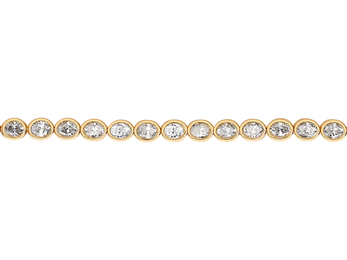 A.G bezel set oval diamond tennis bracelet in yellow gold.