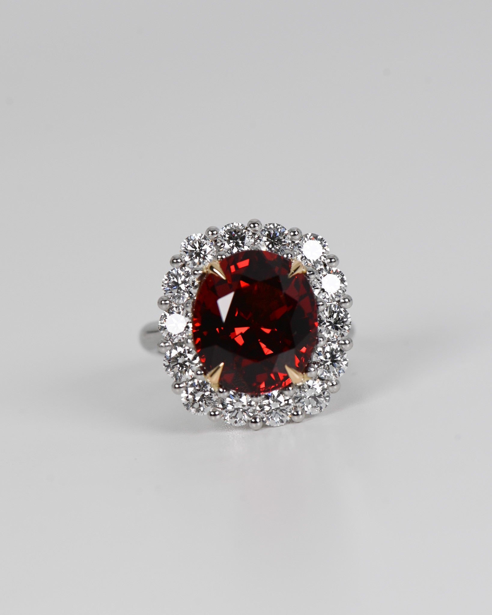 A.G 9.75ct oval cut spessartite garnet and diamond ring
