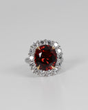 A.G 9.75ct oval cut spessartite garnet and diamond ring