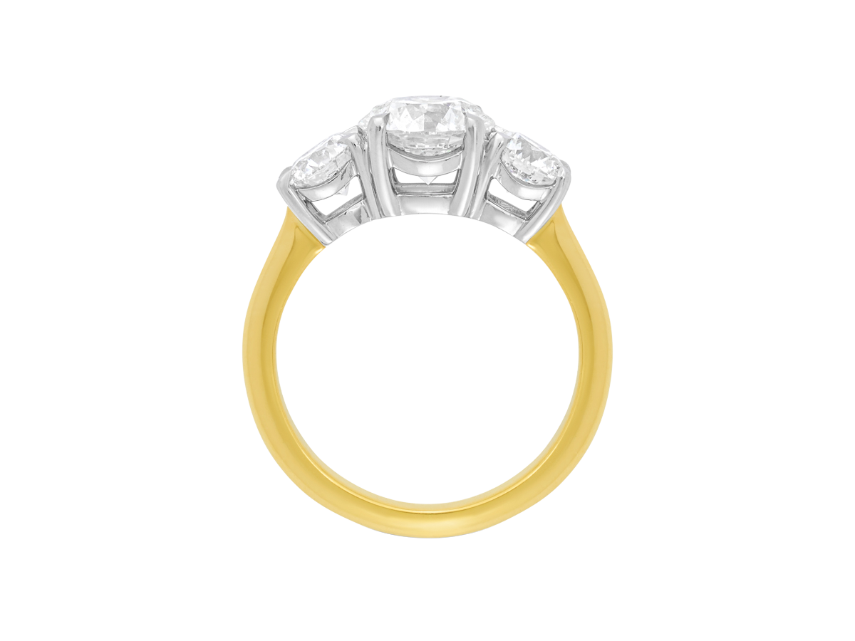Side view of A.G round brilliant cut diamond trilogy four claw setting and half round gold band.