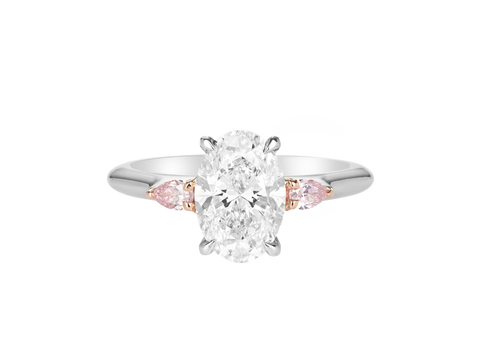 A.G oval cut diamond with pear cut side diamonds in a half round band.