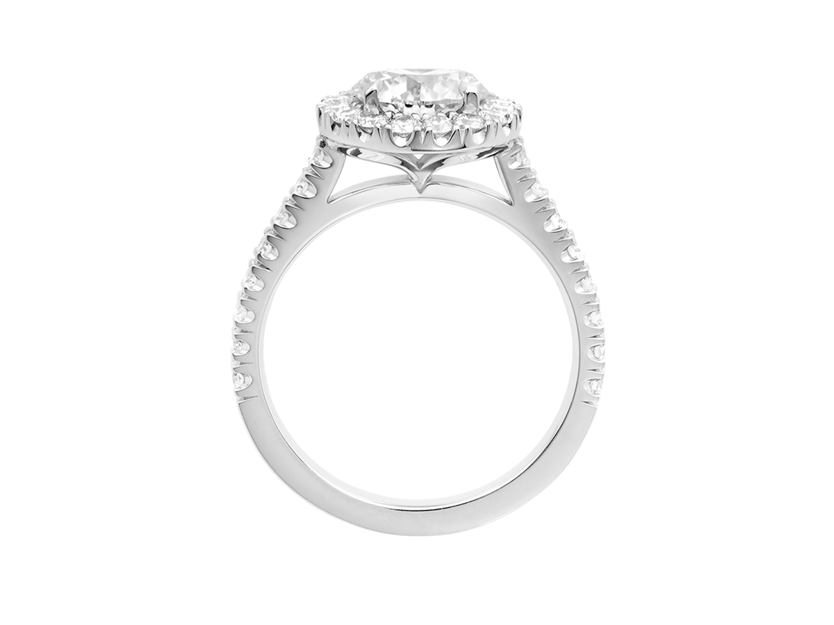 A.G round brilliant cut diamond halo setting with split bead half diamond band.