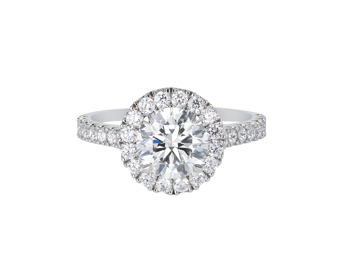 A.G round brilliant cut diamond halo setting with split bead half diamond band.