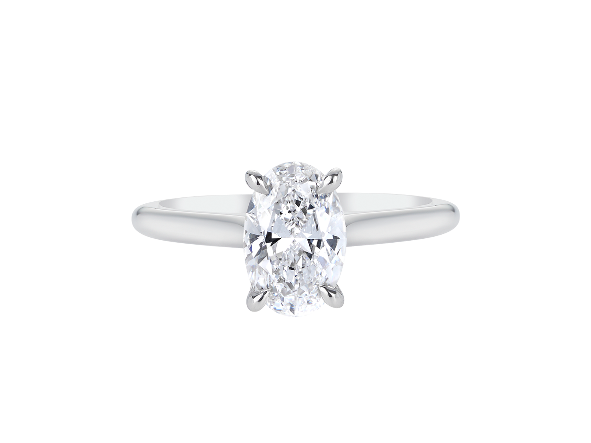 A.G oval cut diamond solitaire four claw setting with a half round band.