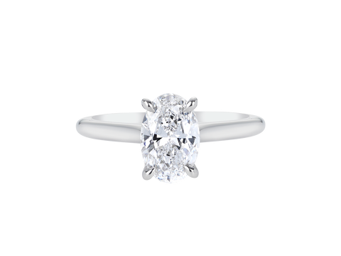 A.G oval cut diamond solitaire four claw setting with a half round band.