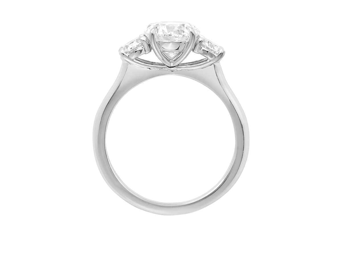 A.G round brilliant cut diamond trilogy four claw setting and half round band in silver.
