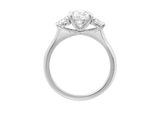 Side view of A.G round brilliant cut diamond trilogy four claw setting and half round band.