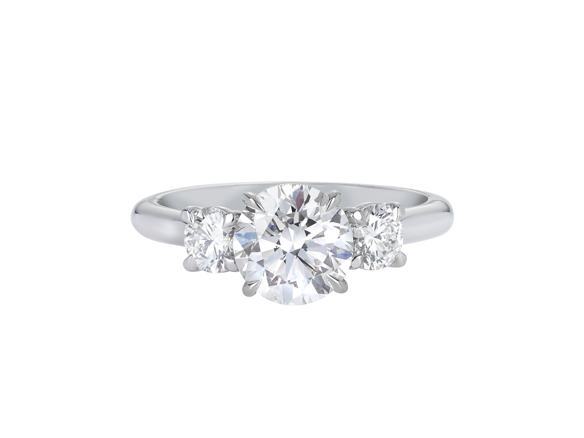A.G round brilliant cut diamond trilogy four claw setting and half round band in silver.