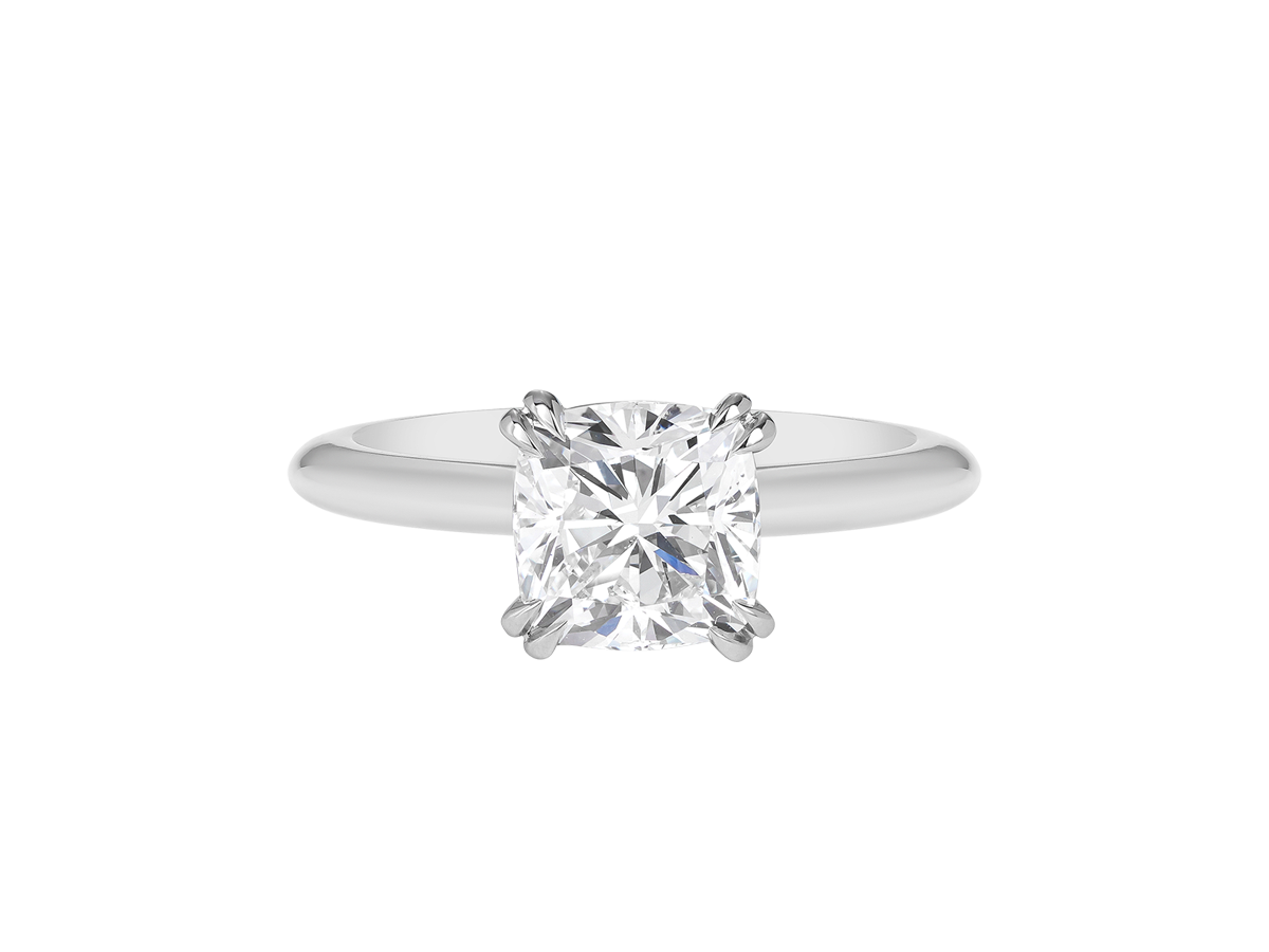 A.G cushion cut solitaire double claw setting with half round band.
