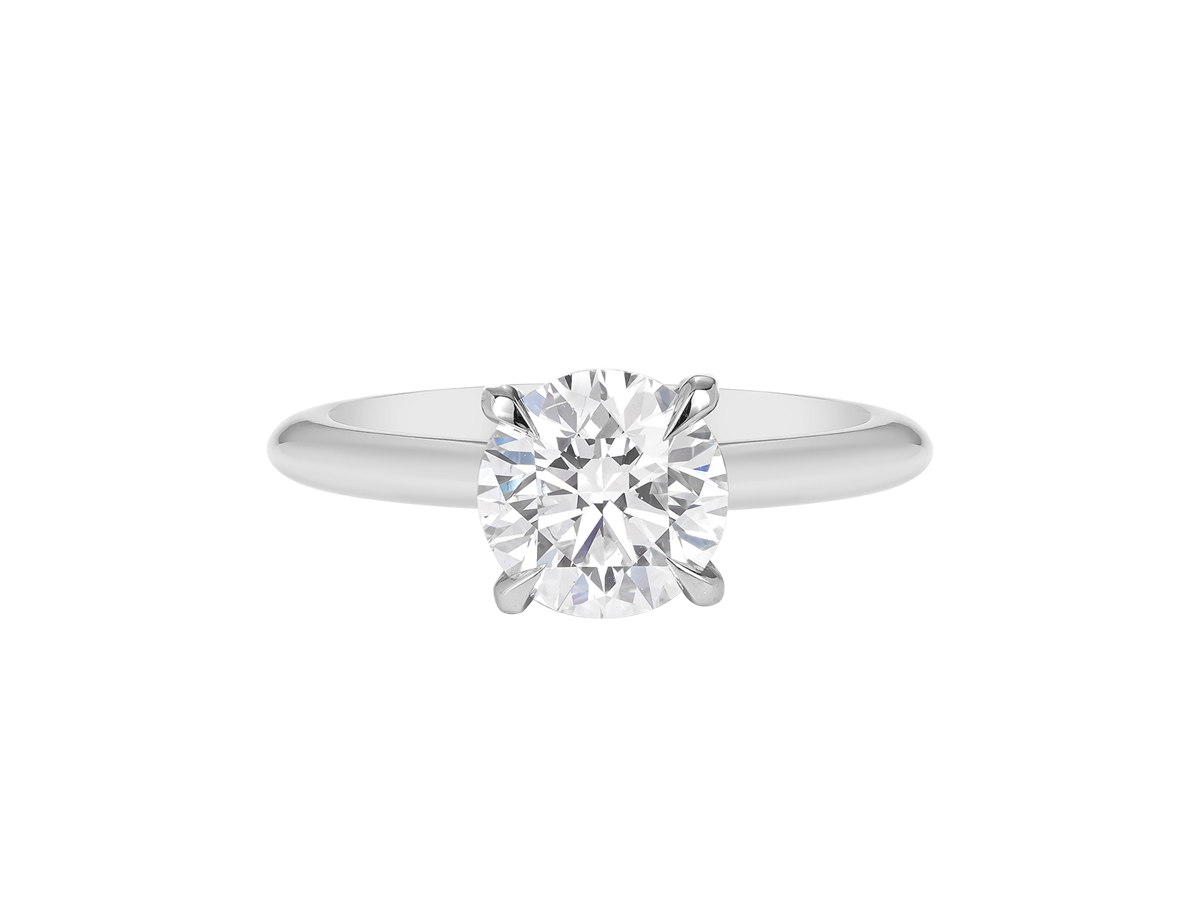 A.G round brilliant cut diamond four claw setting with a half round band.