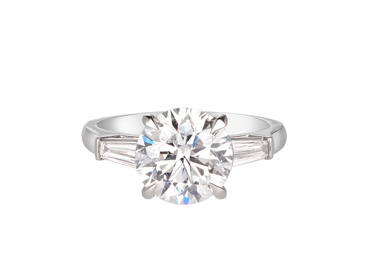 A.G round brilliant cut and tapered baguette diamond trilogy engagement ring.