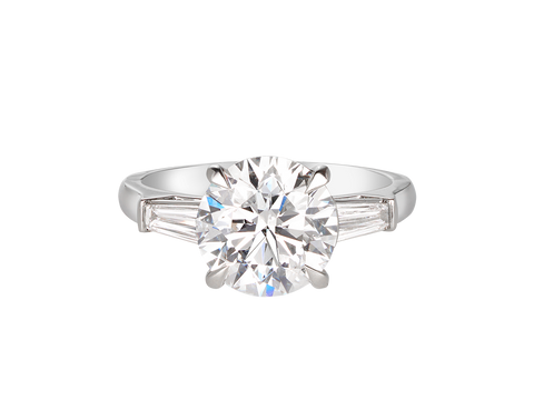 A.G round brilliant cut and tapered baguette diamond trilogy engagement ring.
