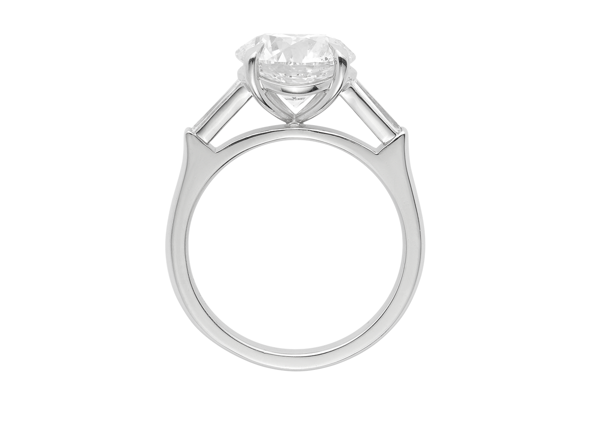 A.G round brilliant cut and tapered baguette diamond trilogy engagement ring.