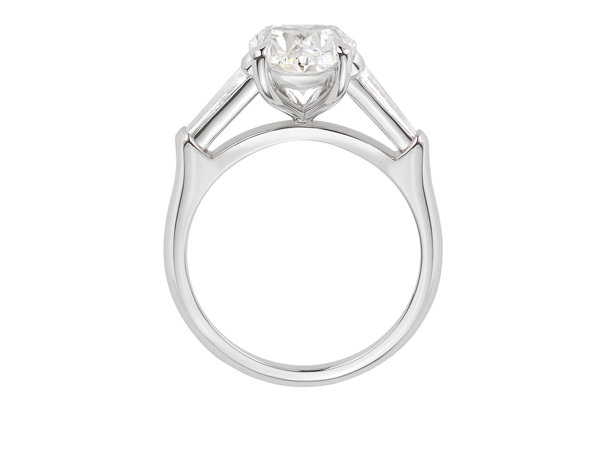 A.G oval cut and tapered baguette diamond engagement ring.