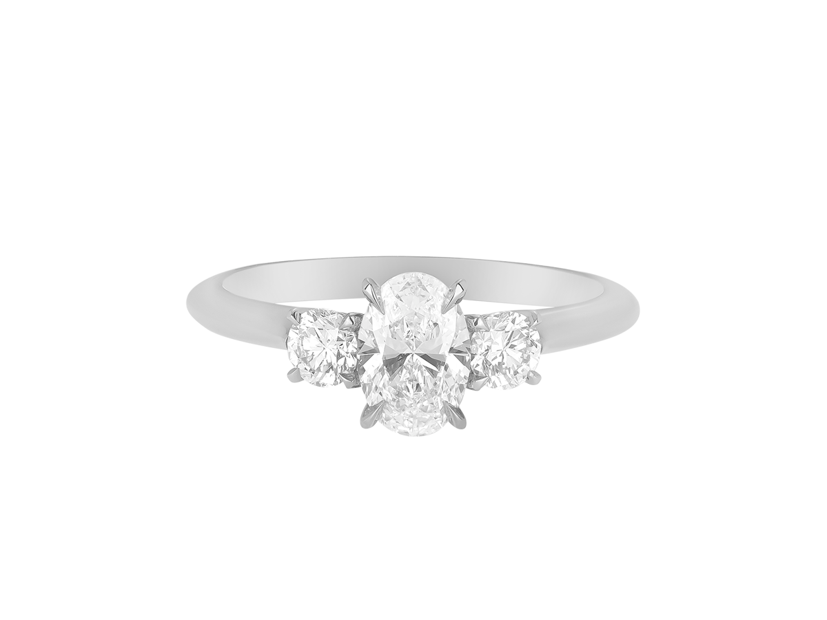 A.G oval cut and round brilliant cut diamond trilogy ring.