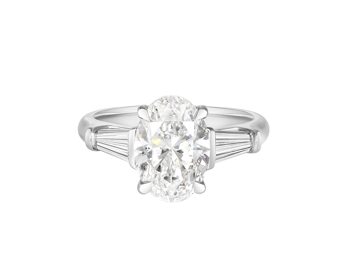 A.G oval cut and tapered baguette diamond engagement ring.
