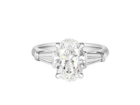 A.G oval cut and tapered baguette diamond engagement ring.