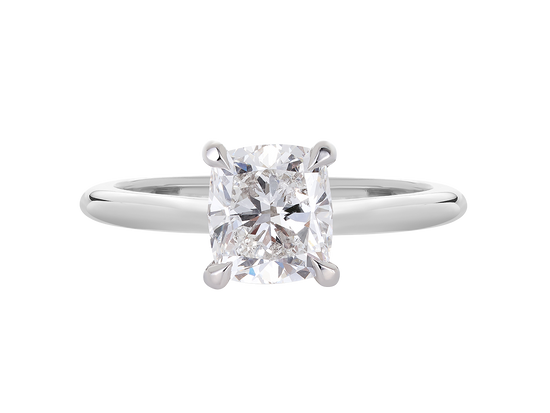 A.G cushion cut solitaire with a round profile band.
