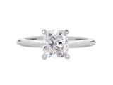 A.G cushion cut solitaire with a round profile band.