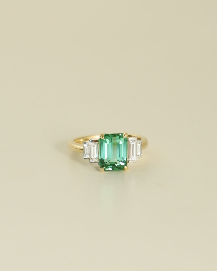 A.G tourmaline and diamond step style ring on beige background.