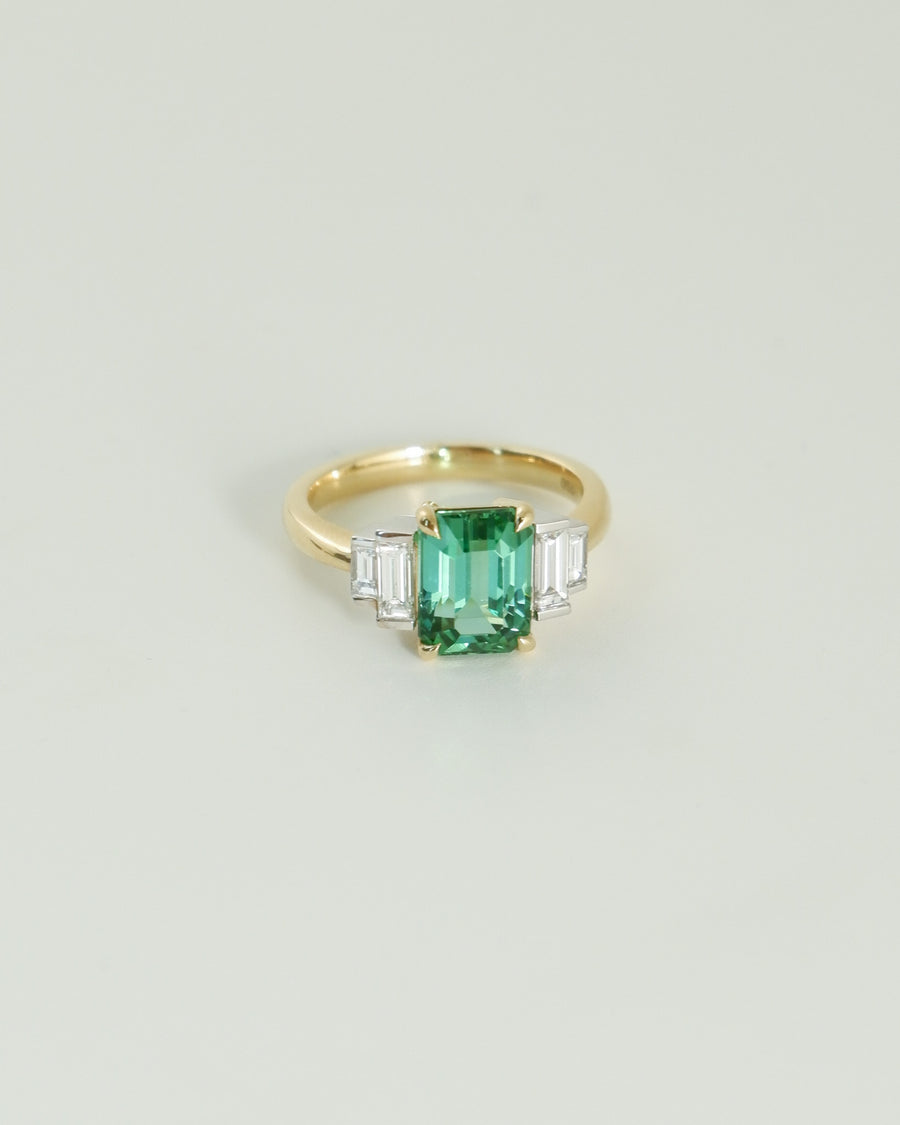 A.G tourmaline and diamond step style ring on white background. 