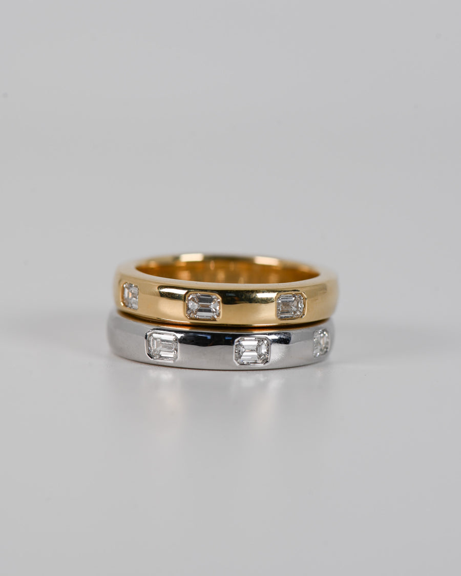 Silver and Gold A.G hammer set emerald cut wedding bands stacked on each other. 