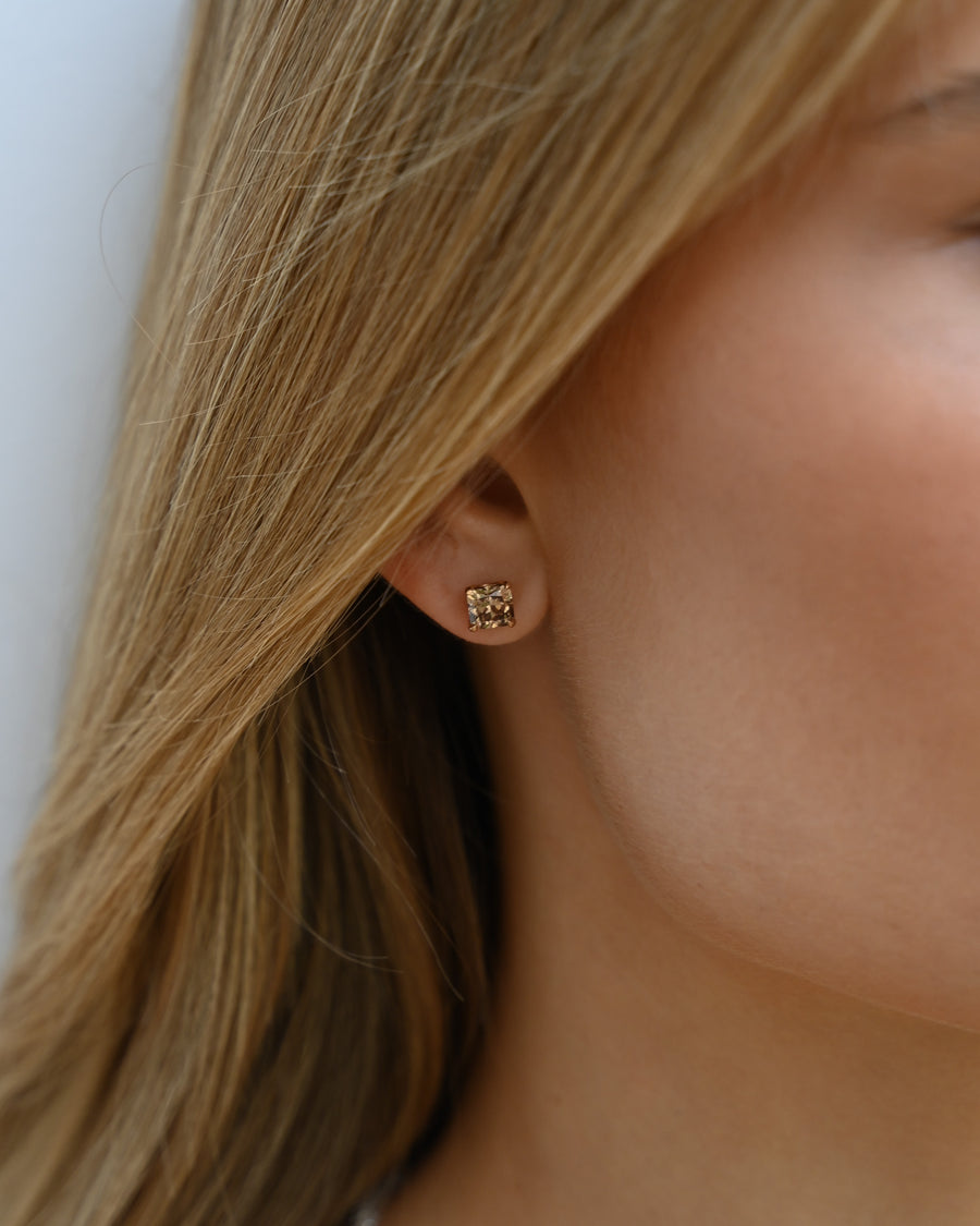 Close up of woman's ear with A.G Designer Jeweller custom designed stud earring with champagne diamonds in rose gold.