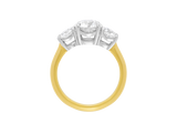 Side view of A.G round brilliant cut diamond trilogy four claw setting and half round gold band.
