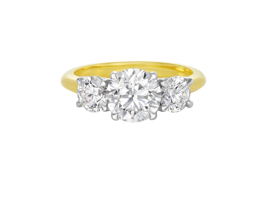 A.G round brilliant cut diamond trilogy four claw setting and half round gold band.