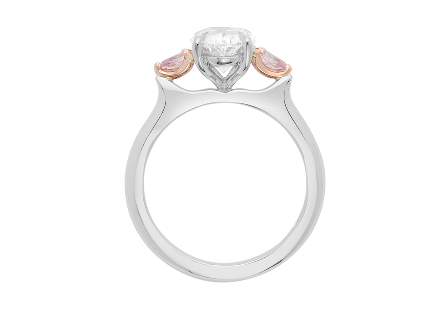 Front view of A.G oval cut diamond with pear cut side diamonds in a half round band.