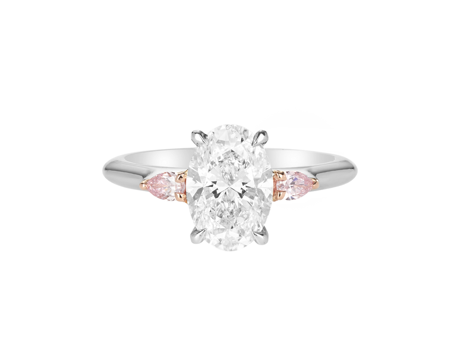 A.G oval cut diamond with pear cut side diamonds in a half round band.