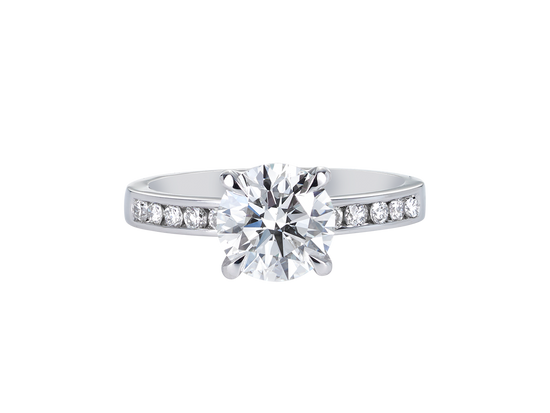 A.G round brilliant cut diamond four claw setting with channel set diamond band.