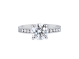 A.G round brilliant cut diamond four claw setting with channel set diamond band.